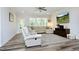 Inviting living room with comfortable seating, a ceiling fan, and lots of natural light from the windows at 2264 Jollay St, Durham, NC 27703