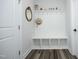Mudroom with built-in storage, coat hooks, and a bench, complemented by wood-look flooring at 2264 Jollay St, Durham, NC 27703