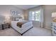 Comfortable bedroom with neutral tones, ample natural light, and stylish furnishings at 237 Tidal Pool Way, Cary, NC 27519