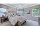 Serene bedroom with a tray ceiling, large windows, and neutral tones, creating a relaxing atmosphere at 237 Tidal Pool Way, Cary, NC 27519