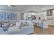 Bright and airy living room with a white sofa, modern art, and view into the kitchen at 237 Tidal Pool Way, Cary, NC 27519