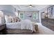 Elegant main bedroom features tray ceilings, soft natural light, and modern furnishings at 237 Tidal Pool Way, Cary, NC 27519