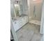Bathroom featuring a double vanity and a walk-in shower with glass door at 2400 Abbeyhill Dr # 36, Raleigh, NC 27610