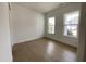 Bedroom with hardwood flooring, neutral walls, and two large windows at 2400 Abbeyhill Dr # 36, Raleigh, NC 27610