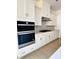 Kitchen featuring stainless steel appliances, tiled backsplash, and white cabinetry at 2400 Abbeyhill Dr # 36, Raleigh, NC 27610