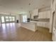 Spacious kitchen area featuring an island, hardwood floors, and modern appliances at 2400 Abbeyhill Dr # 36, Raleigh, NC 27610
