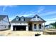 New home being built with Tyvek wrap showing the roof and garage with blue sky background at 2400 Fleming Stone Ln # 52, Raleigh, NC 27610