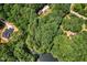 Breathtaking aerial view of the secluded log home amidst lush forest and a serene pond at 2416 Kearney Rd, Wake Forest, NC 27587
