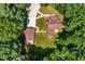 Aerial view of the log home and garage surrounded by beautiful trees, showcasing its private setting at 2416 Kearney Rd, Wake Forest, NC 27587