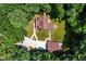 Aerial view of the log home with its detached garage, surrounded by lush greenery and a well-kept lawn at 2416 Kearney Rd, Wake Forest, NC 27587