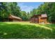 Large backyard featuring luscious lawn, guest house with garage, and private deck at 2416 Kearney Rd, Wake Forest, NC 27587