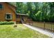 Log home with a cozy porch, deck, and charming fenced-in yard, perfect for enjoying the outdoors at 2416 Kearney Rd, Wake Forest, NC 27587