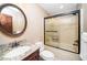 Bathroom showcasing a granite-topped vanity, oval mirror, and tile-surround tub-shower combination at 2416 Kearney Rd, Wake Forest, NC 27587