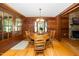 Dining room with wooden table and chairs, wood-paneled walls, and natural light from a bay window at 2416 Kearney Rd, Wake Forest, NC 27587