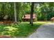 Charming log home with a welcoming front porch, well-maintained lawn, and nestled among beautiful trees at 2416 Kearney Rd, Wake Forest, NC 27587