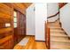 Welcoming home foyer featuring wood walls, a staircase, and a beautiful wooden front door at 2416 Kearney Rd, Wake Forest, NC 27587