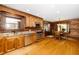 Bright kitchen with stainless steel appliances, wood cabinets, and an adjacent dining area, perfect for Gathering meals at 2416 Kearney Rd, Wake Forest, NC 27587