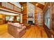 Spacious living room with a stone fireplace, wood paneled walls, and an open floor plan at 2416 Kearney Rd, Wake Forest, NC 27587