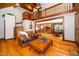 Open-concept living room flows into the kitchen and dining area, featuring wood floors and a staircase at 2416 Kearney Rd, Wake Forest, NC 27587
