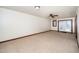 Spacious carpeted living room filled with natural light from large windows and a fan to keep you cool at 2416 Kearney Rd, Wake Forest, NC 27587