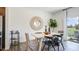 Inviting dining area featuring a sleek table, modern chairs, and sliding glass doors that open to a lovely outdoor space at 2728 Sammish Way, Raleigh, NC 27616