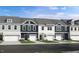 Row of new townhomes with a stone and siding facade, and individual one car garages at 2728 Sammish Way, Raleigh, NC 27616