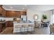 Open-concept kitchen with stainless steel appliances, a breakfast bar, and hardwood floors at 2728 Sammish Way, Raleigh, NC 27616