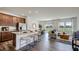 Open-concept living room with a modern kitchen and hardwood floors at 2728 Sammish Way, Raleigh, NC 27616