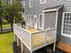 A spacious back deck offers a relaxing outdoor space and entry to the gray home at 2913 Coxindale Dr, Raleigh, NC 27615