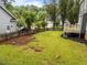 Spacious backyard with green lawn, wooden fence, and deck, perfect for outdoor enjoyment at 2913 Coxindale Dr, Raleigh, NC 27615