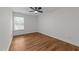 Cozy bedroom featuring wood-look floors and natural light from window at 2913 Coxindale Dr, Raleigh, NC 27615