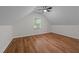 This bedroom features wood-look floors, a ceiling fan, and a dormer window at 2913 Coxindale Dr, Raleigh, NC 27615