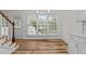 Bright dining area featuring a window wall, wood floors and modern light fixture at 2913 Coxindale Dr, Raleigh, NC 27615