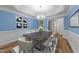 Formal dining area with decorative wainscoting, modern lighting, and seating for eight at 2913 Coxindale Dr, Raleigh, NC 27615