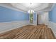 Dining room boasts wainscoting, updated lighting, and natural light from large window at 2913 Coxindale Dr, Raleigh, NC 27615