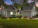 Inviting home exterior showcasing lush landscaping, stone walkway, and gray vinyl siding at 2913 Coxindale Dr, Raleigh, NC 27615