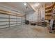 This is a two-car garage with a roll-up door and a ladder along one wall at 2913 Coxindale Dr, Raleigh, NC 27615