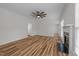 Inviting living room with a cozy fireplace, ceiling fan, and wood-style flooring at 2913 Coxindale Dr, Raleigh, NC 27615