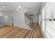 Open living space with wood flooring, staircase, and lots of natural light at 2913 Coxindale Dr, Raleigh, NC 27615