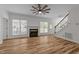 Bright living room with fireplace, ceiling fan, wood-style flooring, and abundant natural light at 2913 Coxindale Dr, Raleigh, NC 27615