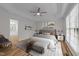 Spacious bedroom with tray ceiling, decorative molding, and ensuite bathroom access at 2913 Coxindale Dr, Raleigh, NC 27615