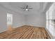 Bright main bedroom boasts tray ceilings, ceiling fan, and wood-look floors at 2913 Coxindale Dr, Raleigh, NC 27615
