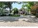 An inviting backyard features a stone patio with seating and a red umbrella perfect for relaxing or entertaining at 308 W Whitaker Mill Rd, Raleigh, NC 27608