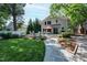 Charming backyard features a stone patio with seating, complemented by manicured landscaping and a two-story home at 308 W Whitaker Mill Rd, Raleigh, NC 27608