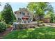 Charming backyard features a stone patio, seating and landscaped garden, complemented by a well-maintained two-story home at 308 W Whitaker Mill Rd, Raleigh, NC 27608