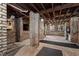 Unfinished basement showcasing exposed brick columns, wood beams, and concrete floors at 308 W Whitaker Mill Rd, Raleigh, NC 27608