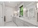 Elegant bathroom with dual marble vanity, subway tile accents, and modern fixtures, offering a spa-like experience at 308 W Whitaker Mill Rd, Raleigh, NC 27608