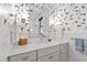 Stylish bathroom with modern fixtures, white subway tiles, and unique wallpaper at 308 W Whitaker Mill Rd, Raleigh, NC 27608