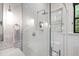 Modern bathroom with tiled shower, glass door, and sleek fixtures at 308 W Whitaker Mill Rd, Raleigh, NC 27608