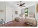 Guest bedroom with two twin beds and patterned area rug at 308 W Whitaker Mill Rd, Raleigh, NC 27608